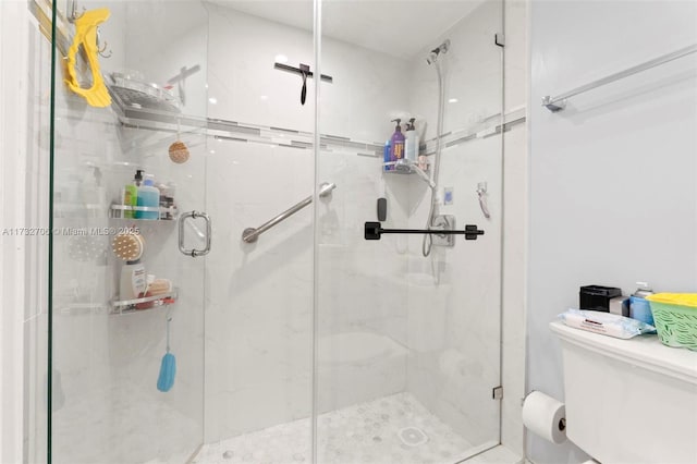 bathroom with an enclosed shower and toilet