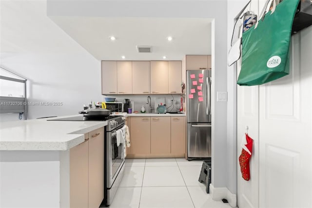 kitchen with light tile patterned flooring, sink, light brown cabinets, kitchen peninsula, and stainless steel appliances