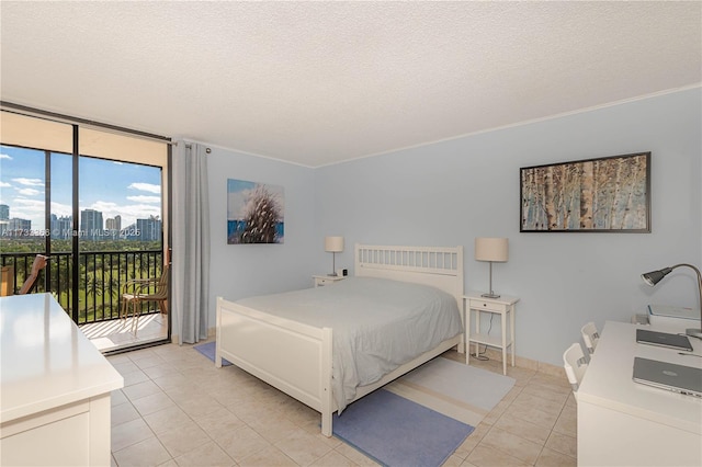 bedroom with access to outside, light tile patterned flooring, a textured ceiling, and a wall of windows