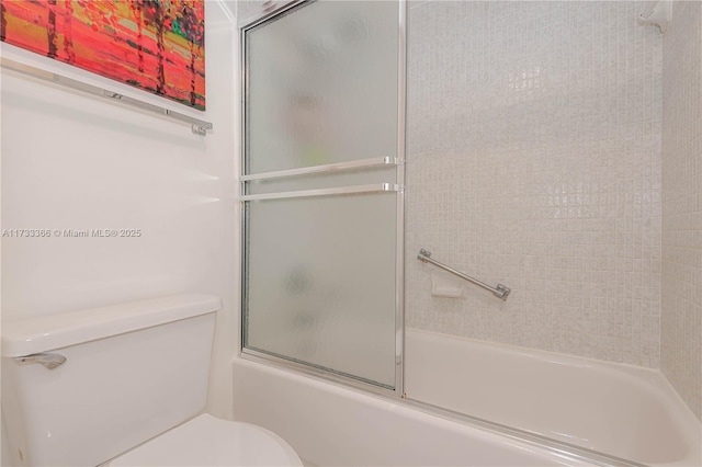 bathroom featuring shower / bath combination with glass door and toilet