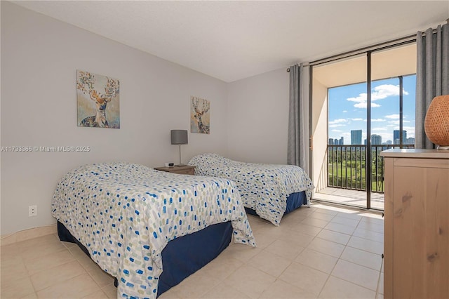 bedroom featuring light tile patterned floors, access to outside, and expansive windows