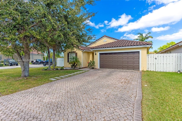 view of front of house with a garage, a front yard, decorative driveway, and a tile roof