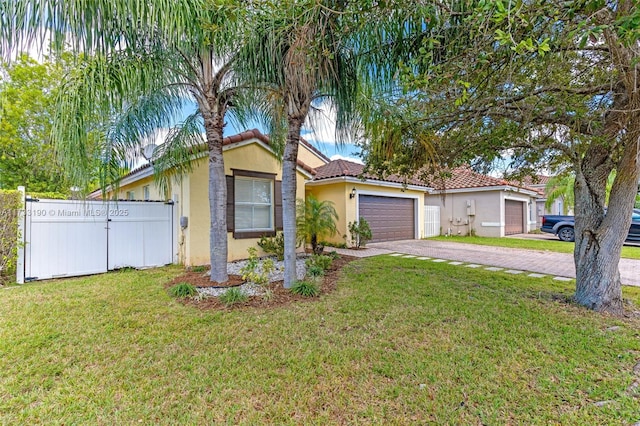 view of front facade with stucco siding, a front yard, fence, a garage, and driveway