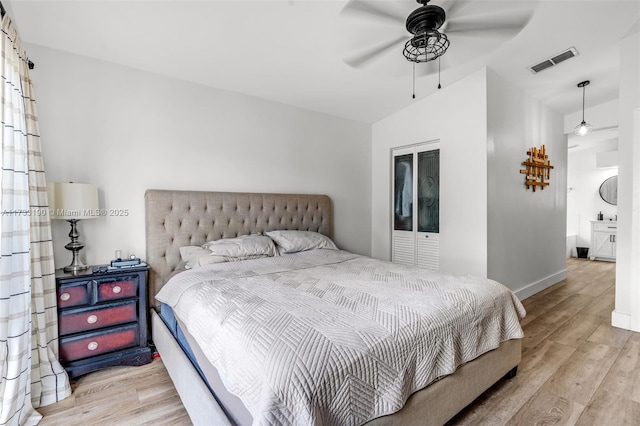 bedroom featuring ceiling fan, wood finished floors, visible vents, and baseboards