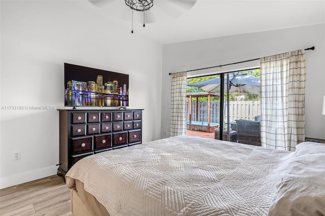 bedroom featuring access to outside, ceiling fan, baseboards, and wood finished floors