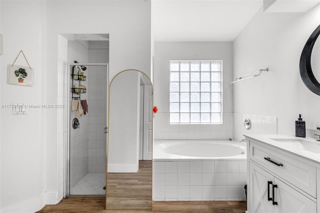 full bathroom with vanity, a stall shower, wood finished floors, and a bath