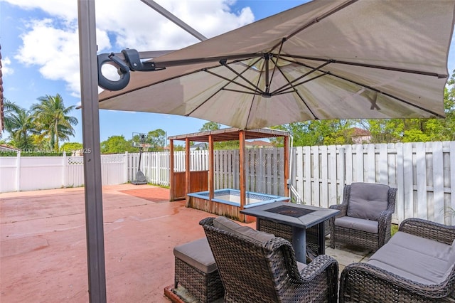 view of patio featuring an outdoor fire pit and a fenced backyard