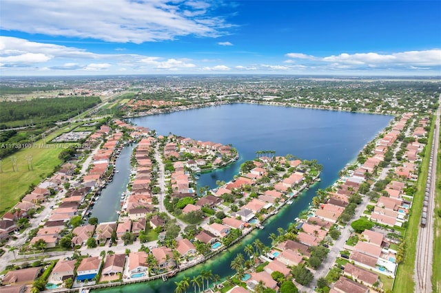 birds eye view of property with a water view and a residential view