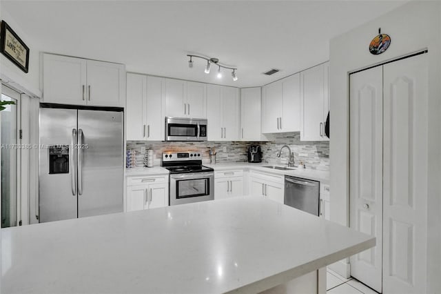 kitchen featuring white cabinetry, appliances with stainless steel finishes, and light countertops