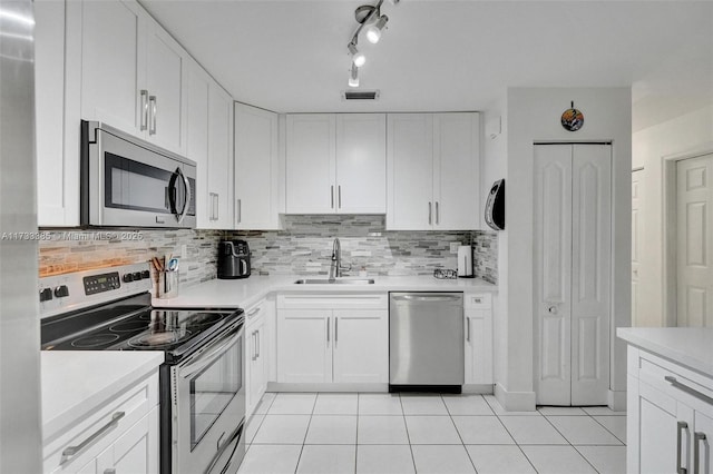 kitchen featuring visible vents, white cabinets, appliances with stainless steel finishes, light countertops, and a sink