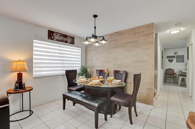 dining room featuring light tile patterned floors and baseboards