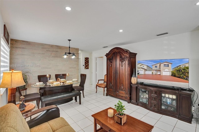 living room with a chandelier, light tile patterned flooring, visible vents, and recessed lighting