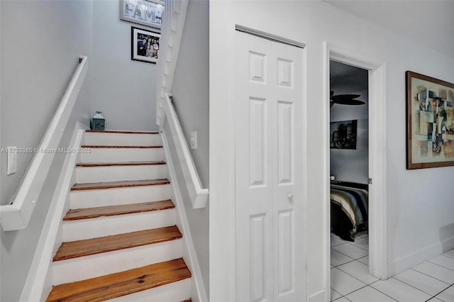 stairway with tile patterned flooring and baseboards