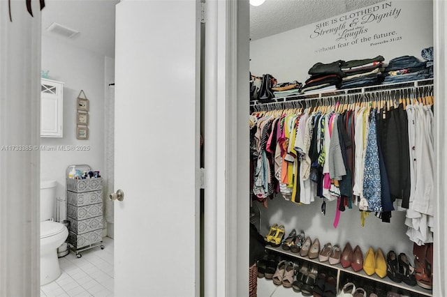 spacious closet featuring light tile patterned floors and visible vents