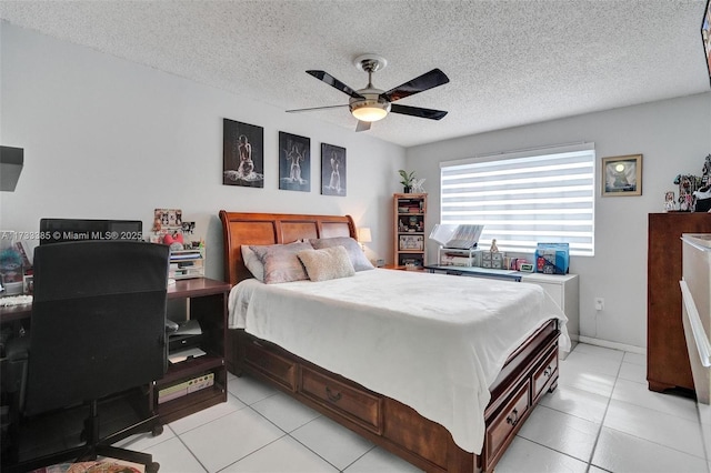 bedroom featuring a textured ceiling, ceiling fan, and light tile patterned flooring