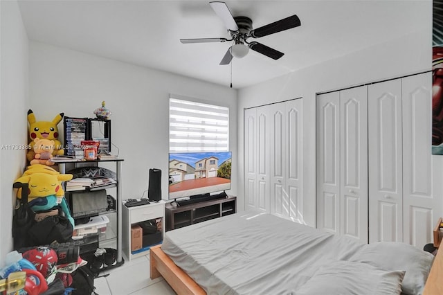 bedroom featuring ceiling fan and two closets