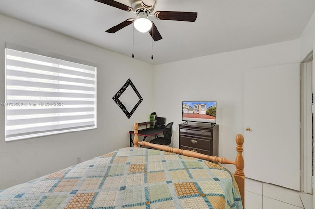 bedroom with ceiling fan and light tile patterned floors