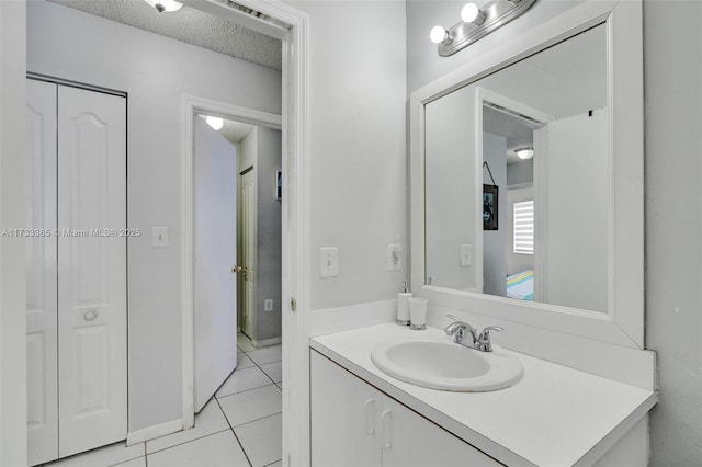 bathroom featuring a textured ceiling, visible vents, vanity, a closet, and tile patterned floors