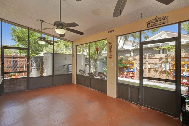 unfurnished sunroom with vaulted ceiling and ceiling fan