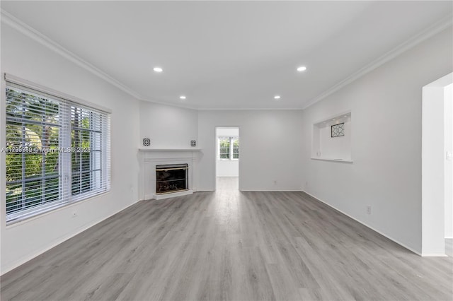 unfurnished living room featuring crown molding and light hardwood / wood-style floors