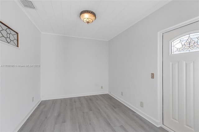 entrance foyer featuring light hardwood / wood-style flooring and ornamental molding