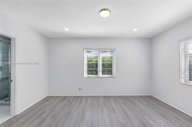 unfurnished room with plenty of natural light and light hardwood / wood-style floors