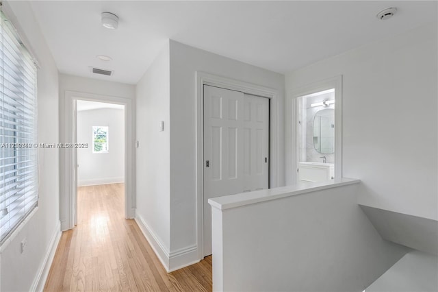 corridor featuring light hardwood / wood-style floors