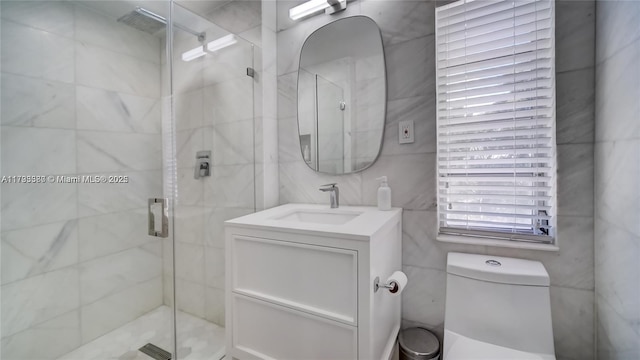 bathroom with vanity, a shower with door, and toilet