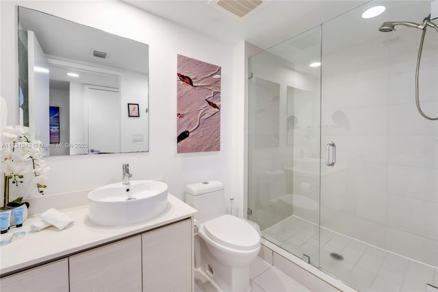 bathroom with walk in shower, vanity, and toilet