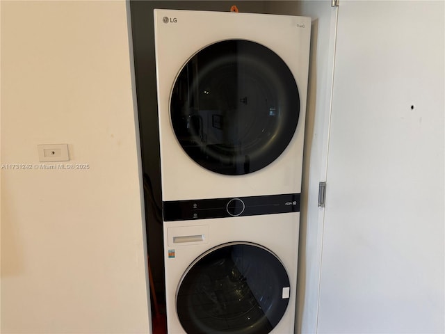 clothes washing area with stacked washer / drying machine