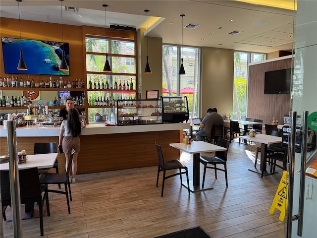 dining space with bar and expansive windows