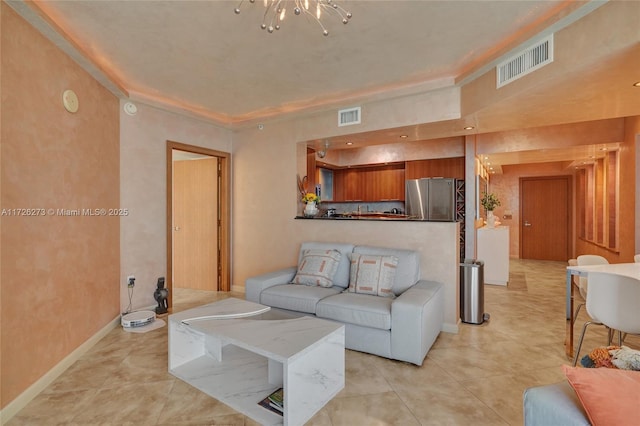 tiled living room with a raised ceiling and a notable chandelier