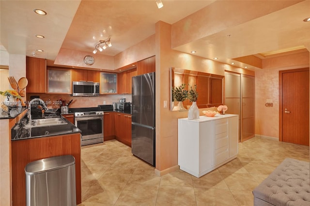 kitchen featuring appliances with stainless steel finishes, sink, light tile patterned floors, and backsplash