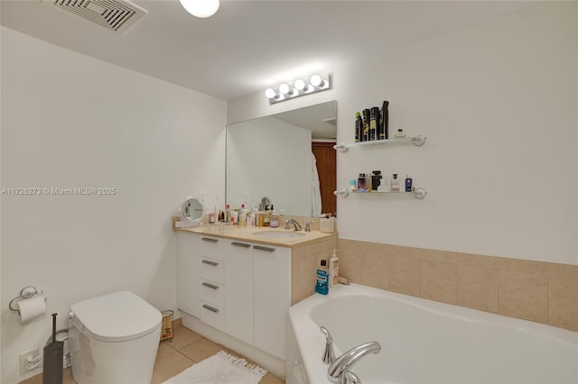 bathroom featuring vanity, toilet, tile patterned flooring, and a washtub