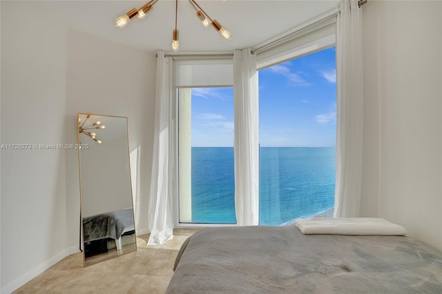 bedroom with multiple windows and a water view