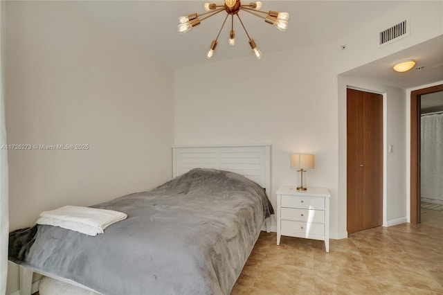 bedroom with a chandelier and a closet