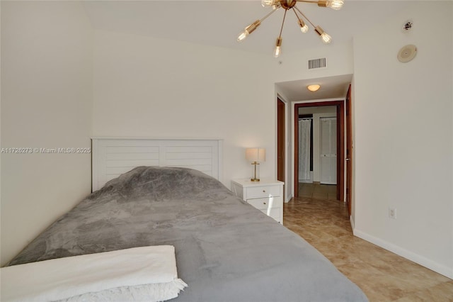 bedroom featuring a notable chandelier