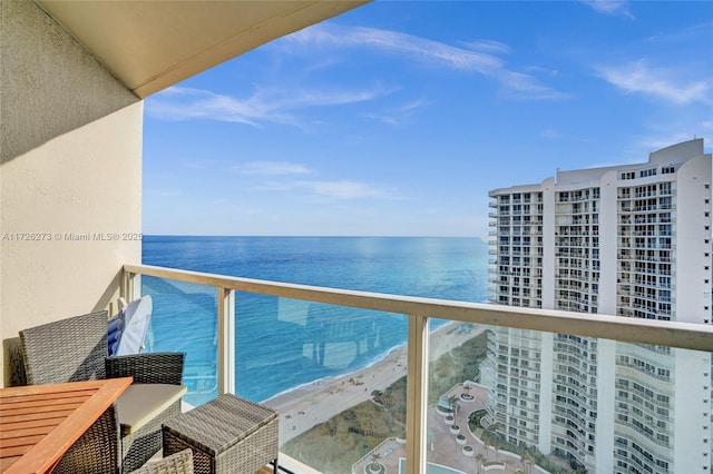 balcony with a water view and a beach view