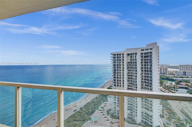 balcony featuring a water view and a beach view