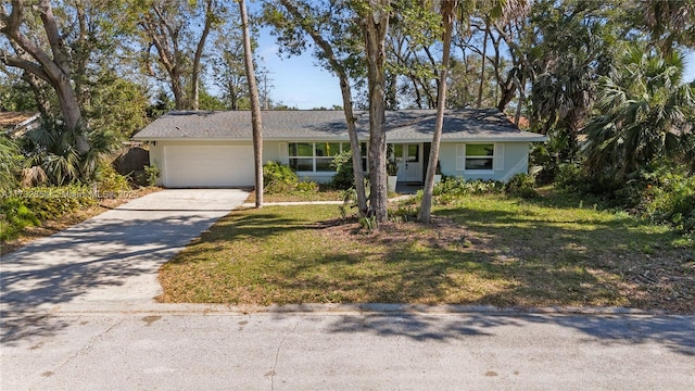 ranch-style home with a garage and a front lawn