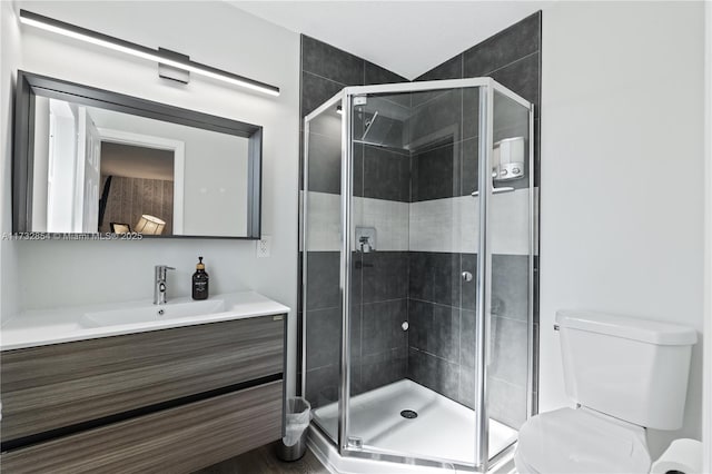 bathroom with walk in shower, vanity, and toilet