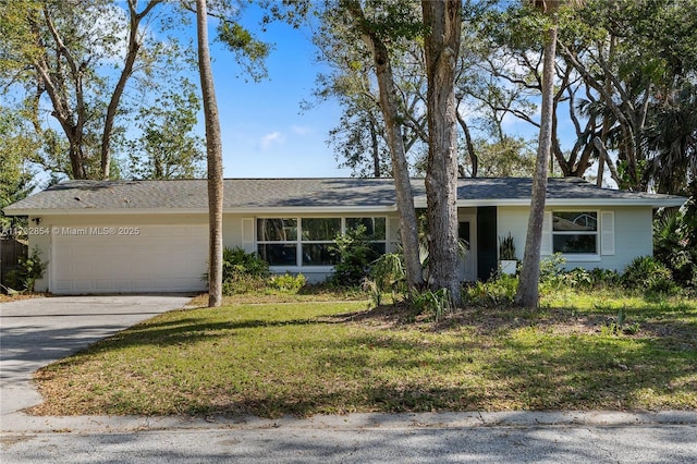 single story home featuring a garage and a front lawn