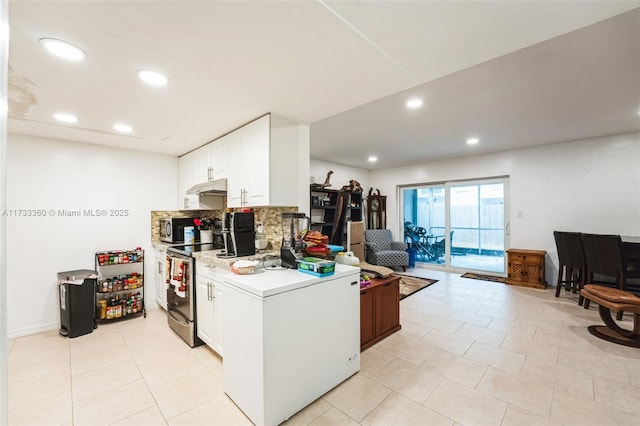 kitchen with tasteful backsplash, light tile patterned flooring, white cabinets, and appliances with stainless steel finishes