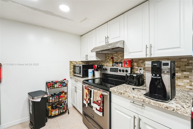 kitchen featuring white cabinetry, decorative backsplash, light tile patterned floors, stainless steel appliances, and light stone countertops