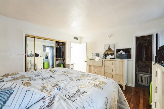 bedroom featuring dark hardwood / wood-style floors and a closet