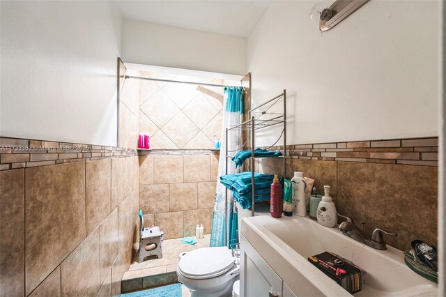 bathroom with vanity, tile walls, curtained shower, and toilet