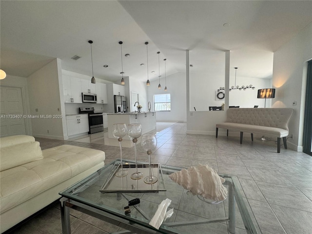 tiled living room with vaulted ceiling and sink