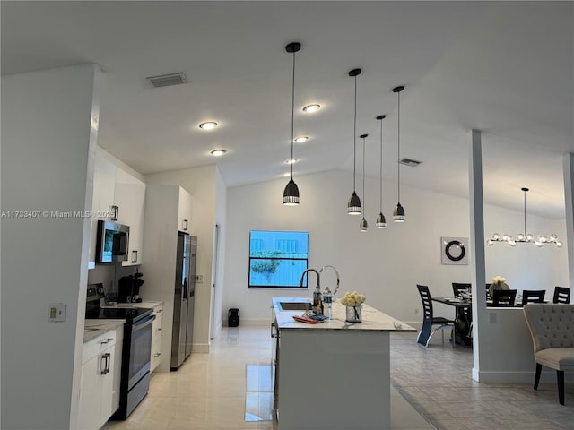 kitchen featuring stainless steel appliances, white cabinetry, vaulted ceiling, and pendant lighting