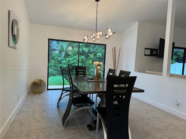 dining area with light tile patterned floors and a chandelier