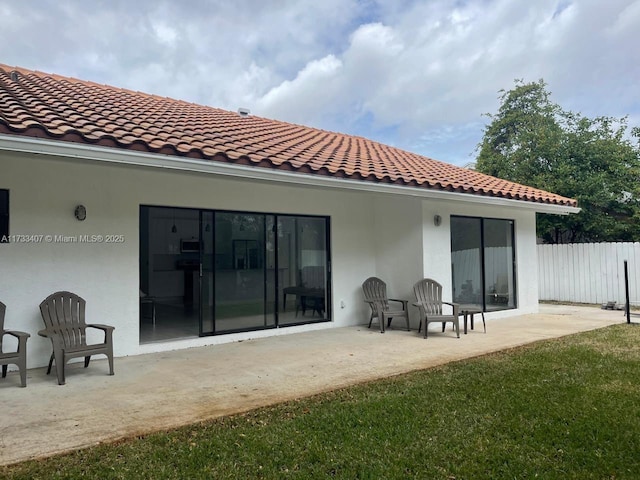 back of house with a yard and a patio area